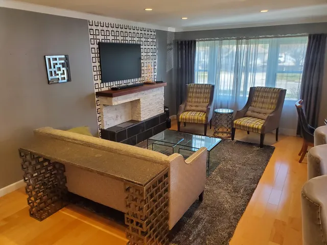 a dining room with furniture and large windows