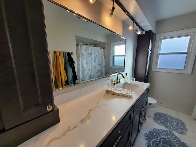 a spacious bathroom with a large mirror