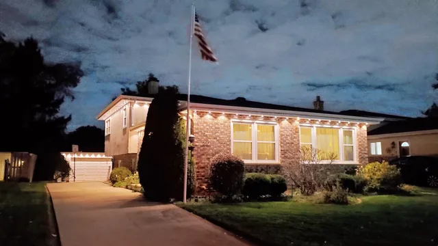 a front view of a house with a garden