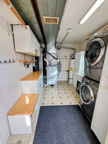 a view of a chair and table in the back yard of the house