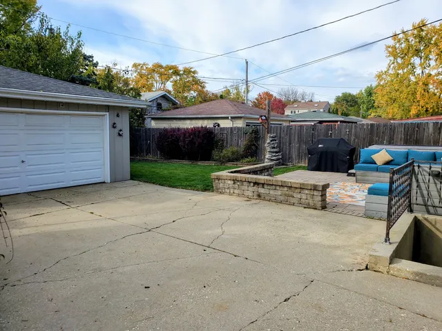 a wooden bench sitting in front of a house