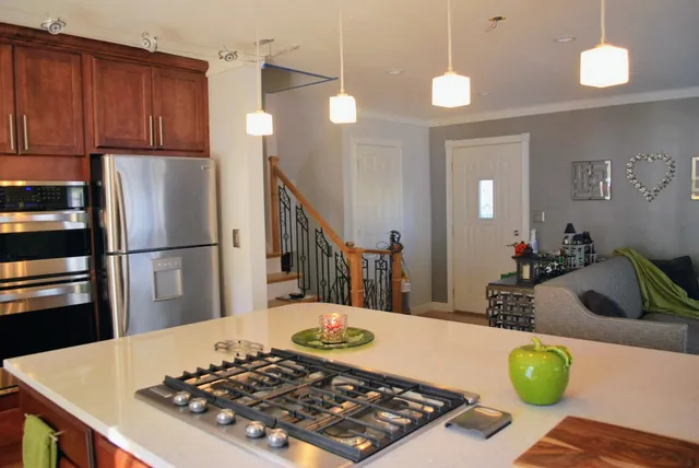 a kitchen with a table a stove and cabinets