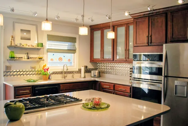 a kitchen with stainless steel appliances granite countertop a stove and a refrigerator