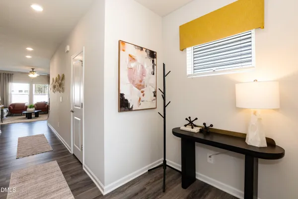 a view of a hallway with workspace and a mirror