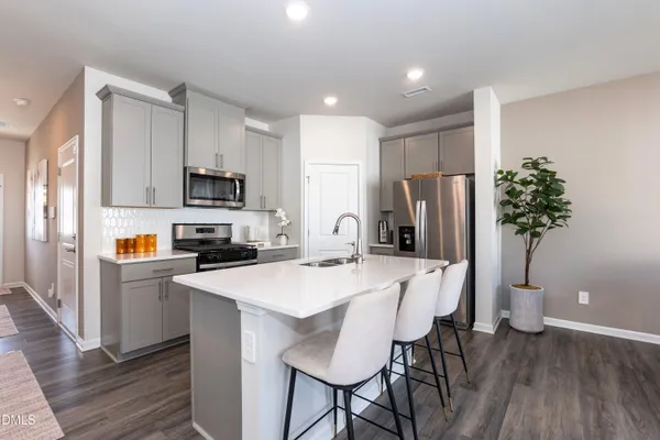a kitchen with appliances a refrigerator and a counter space