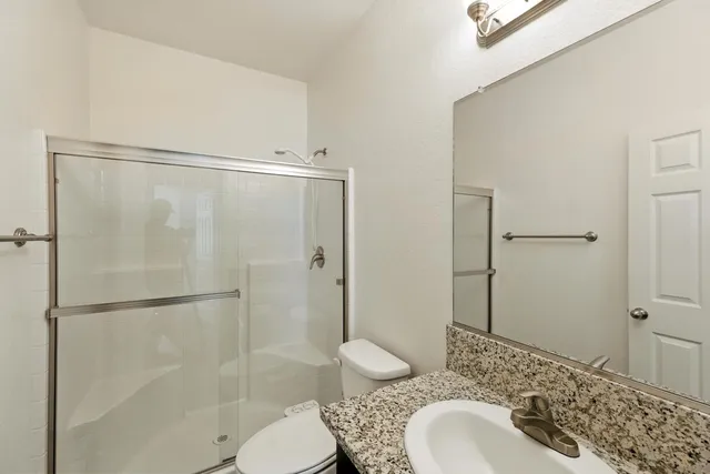 a bathroom with a sink toilet and shower