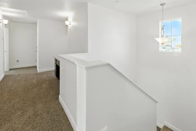 a view of hallway with wooden floor
