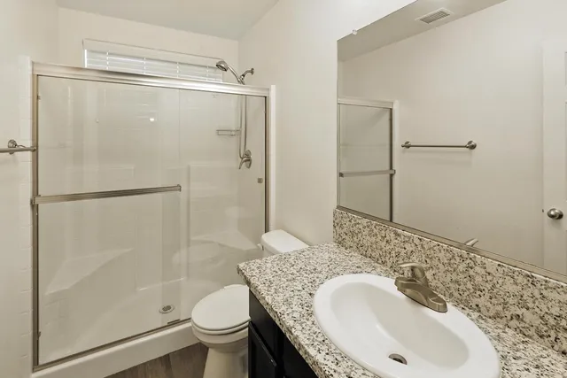 a bathroom with a sink toilet and shower