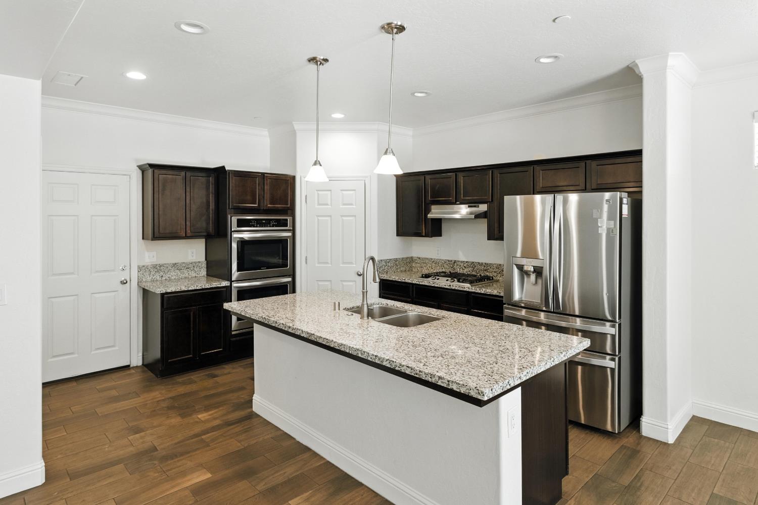1732 Cleveland Street Selma, CA 93662 - Photo 3 of 24 a kitchen with stainless steel appliances granite countertop a refrigerator a sink and a stove