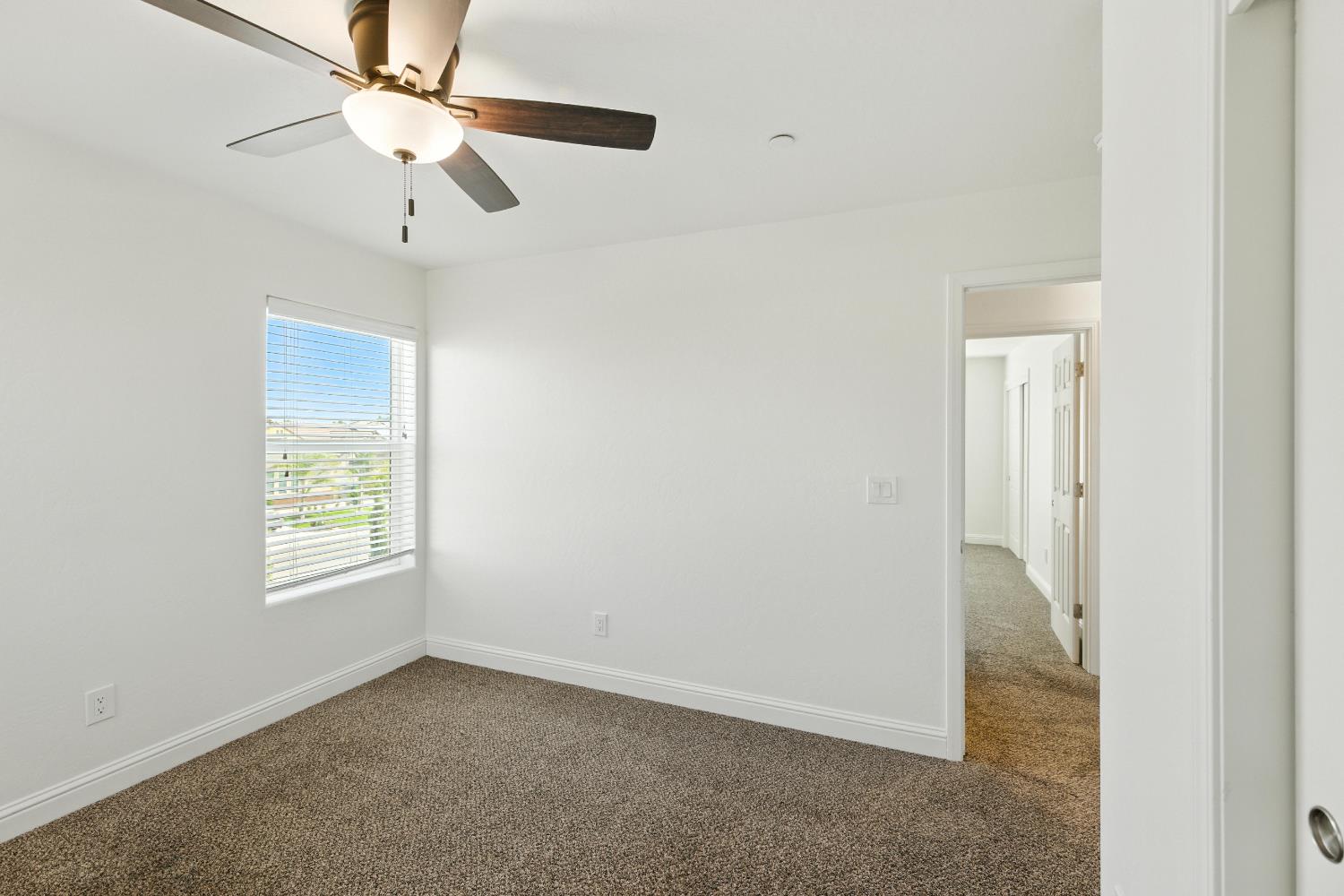 1732 Cleveland Street Selma, CA 93662 - Photo 10 of 24 an empty room with windows and fan