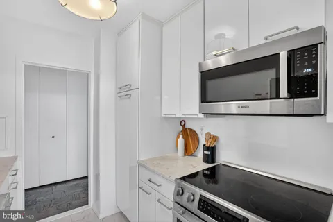 a kitchen with stainless steel appliances a sink a stove and microwave