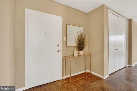 a view of a livingroom with wooden floor and a hallway