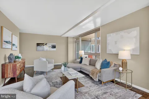 a living room with furniture and a lamp on table