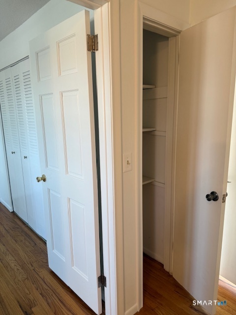 280 East Main Street, Unit E2 Clinton, CT 06413 - Photo 16 of 20 The upstairs hall has a closet with shelving. Door to second bedroom on the left and primary bedroom door is to the right.