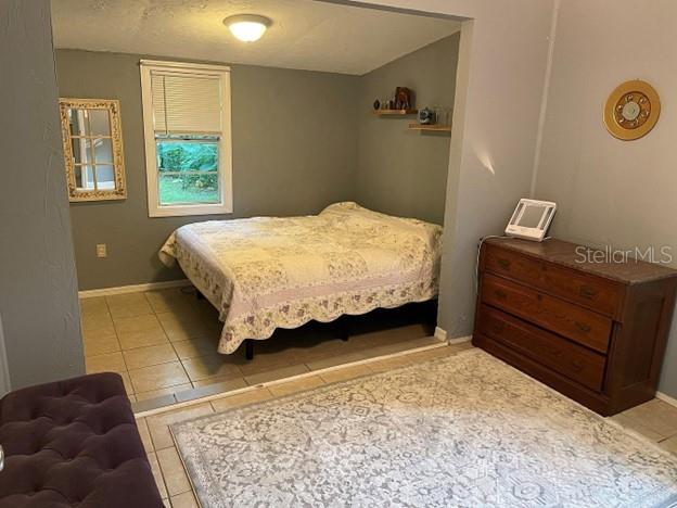 13608 Northwest 145 Avenue Alachua, FL 32615 - Photo 5 of 10 a bedroom with a bed and a dresser