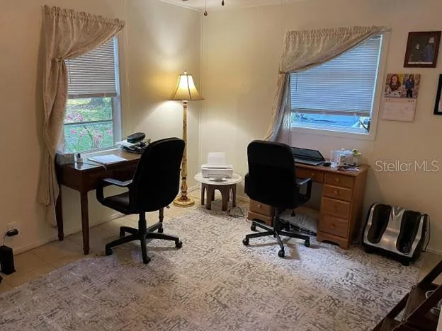 a view of a workspace with furniture and a window