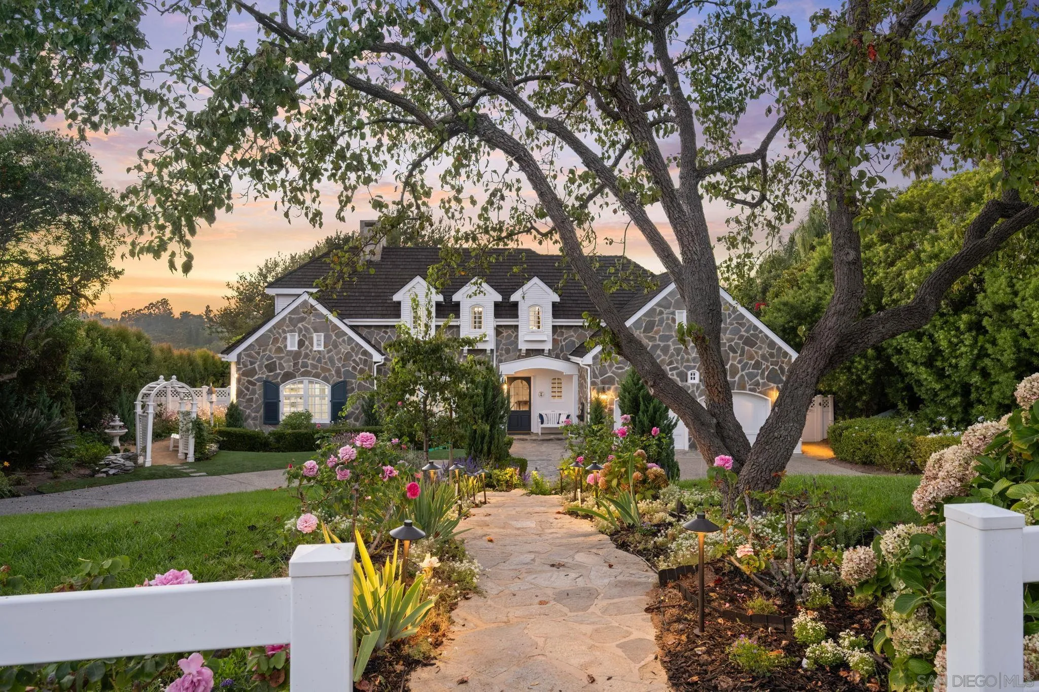 5618 Loma Verde Drive Rancho Santa Fe, CA 92067 - Photo 1 of 39 a front view of a house with garden