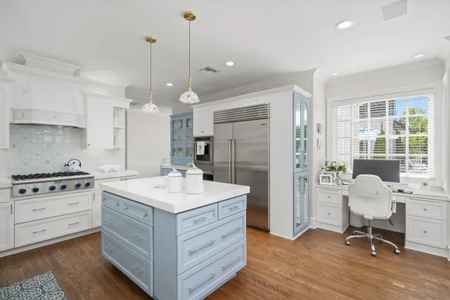a kitchen with a stove a refrigerator and a dining table