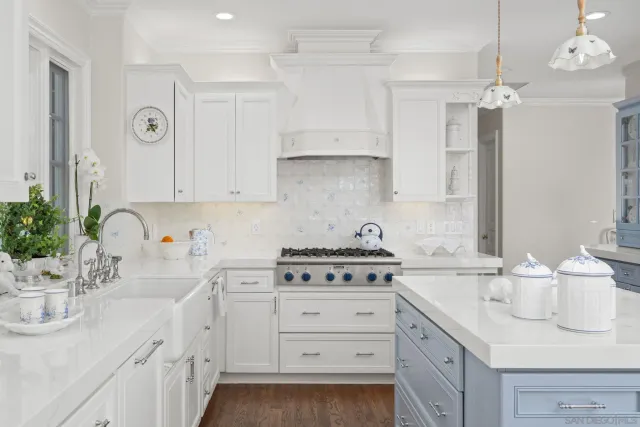 a kitchen with cabinets appliances a sink and a counter top space