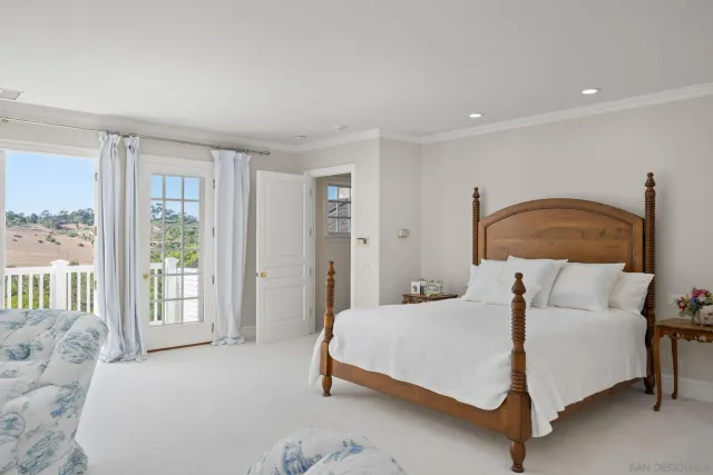 a bedroom with a bed lamp and window