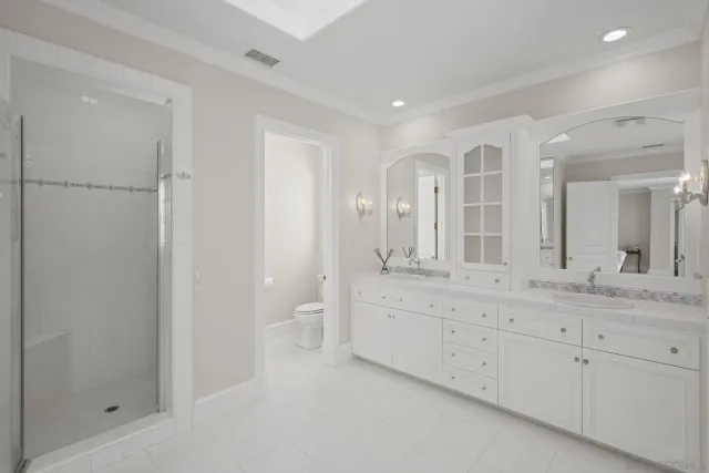a spacious bathroom with a granite countertop sink mirror and double