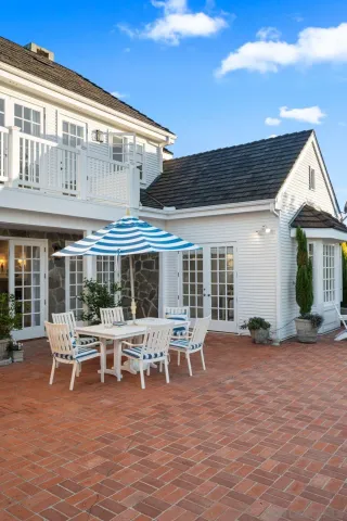 a view of a house with backyard porch and sitting area