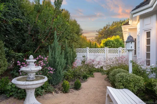 a view of a fountain in back yard of the house