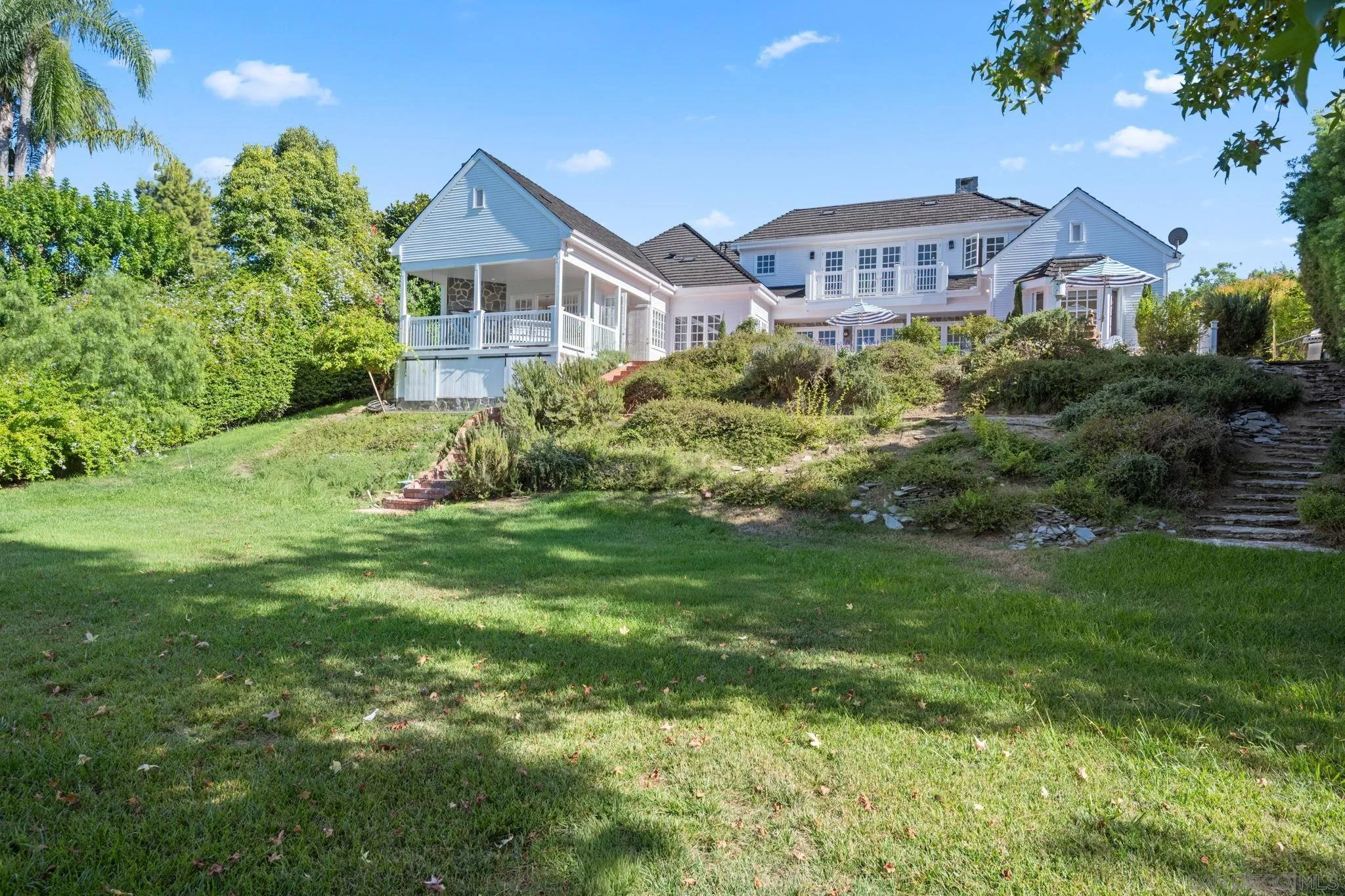 5618 Loma Verde Drive Rancho Santa Fe, CA 92067 - Photo 34 of 39 a front view of a house with a yard