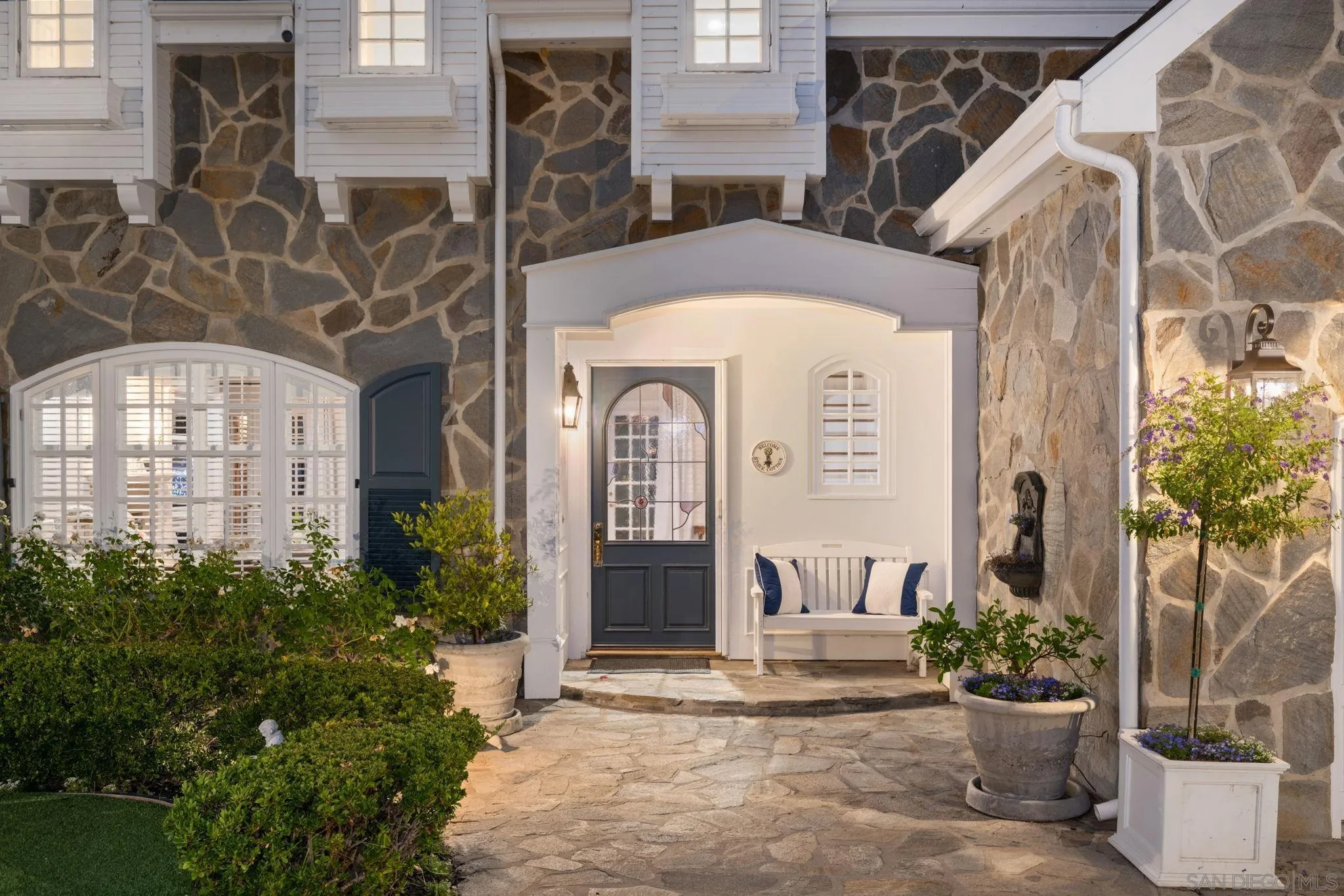 5618 Loma Verde Drive Rancho Santa Fe, CA 92067 - Photo 4 of 39 a front view of a building with potted plants