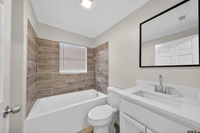 an empty room with a ceiling fan and windows