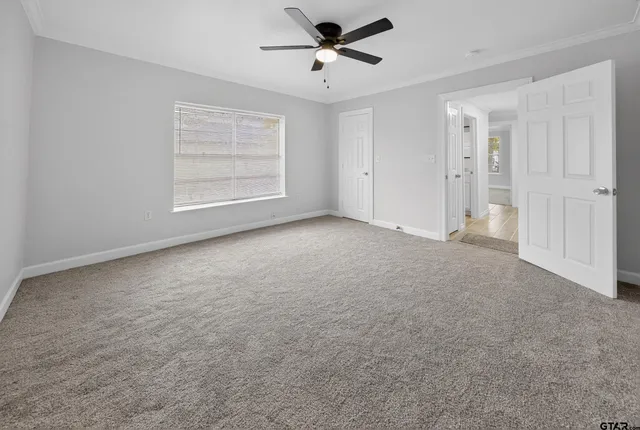 a view of an empty room with a window