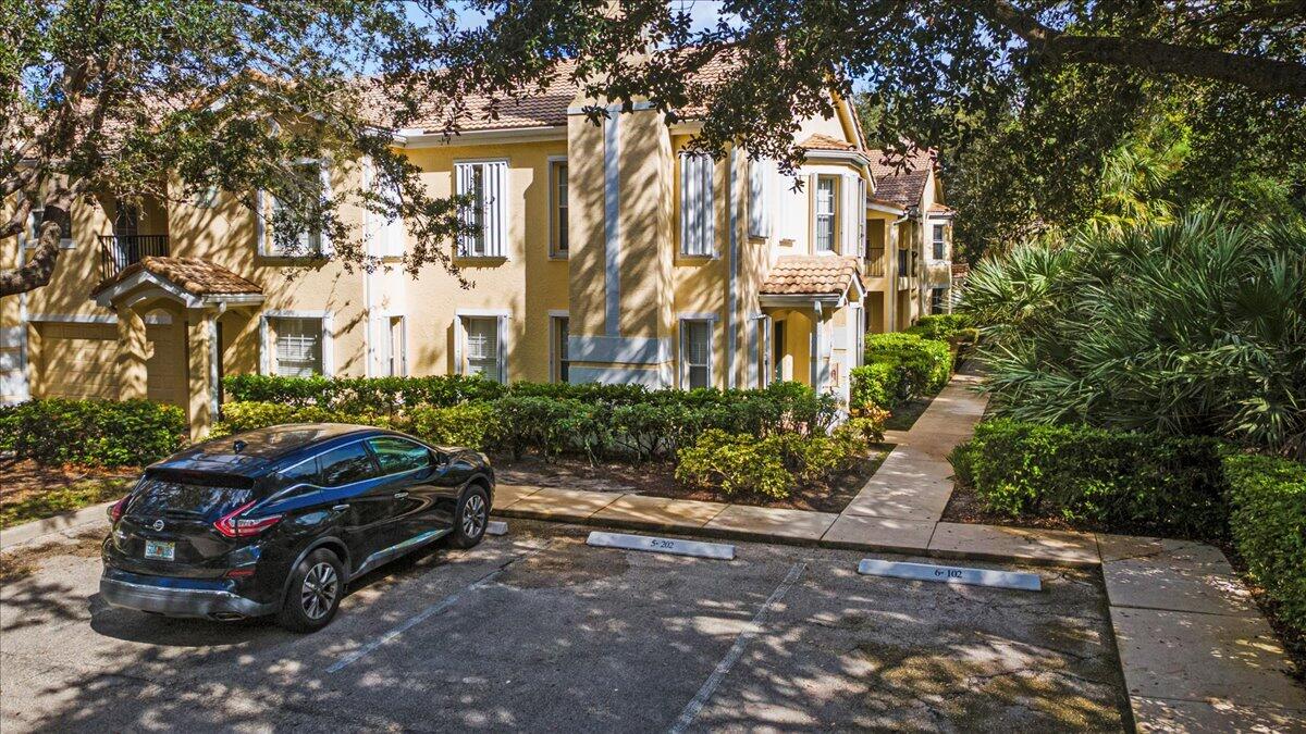 110 Southwest Peacock Boulevard, Unit 6101 Port St. Lucie, FL 34986 - Photo 11 of 70 a car parked in front of a brick house