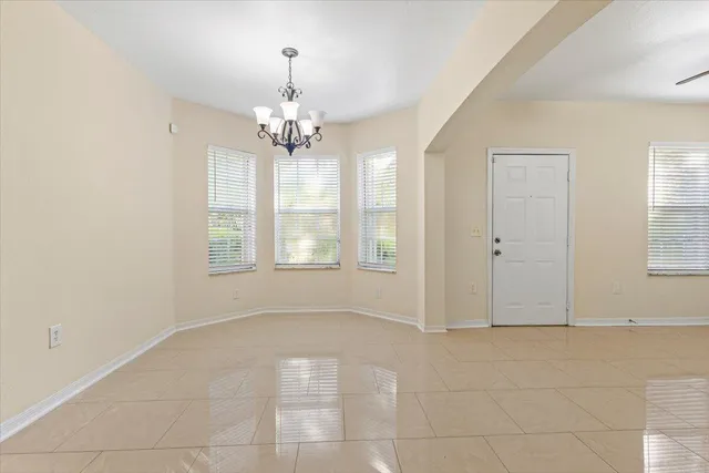 a kitchen with granite countertop white cabinets and stainless steel appliances
