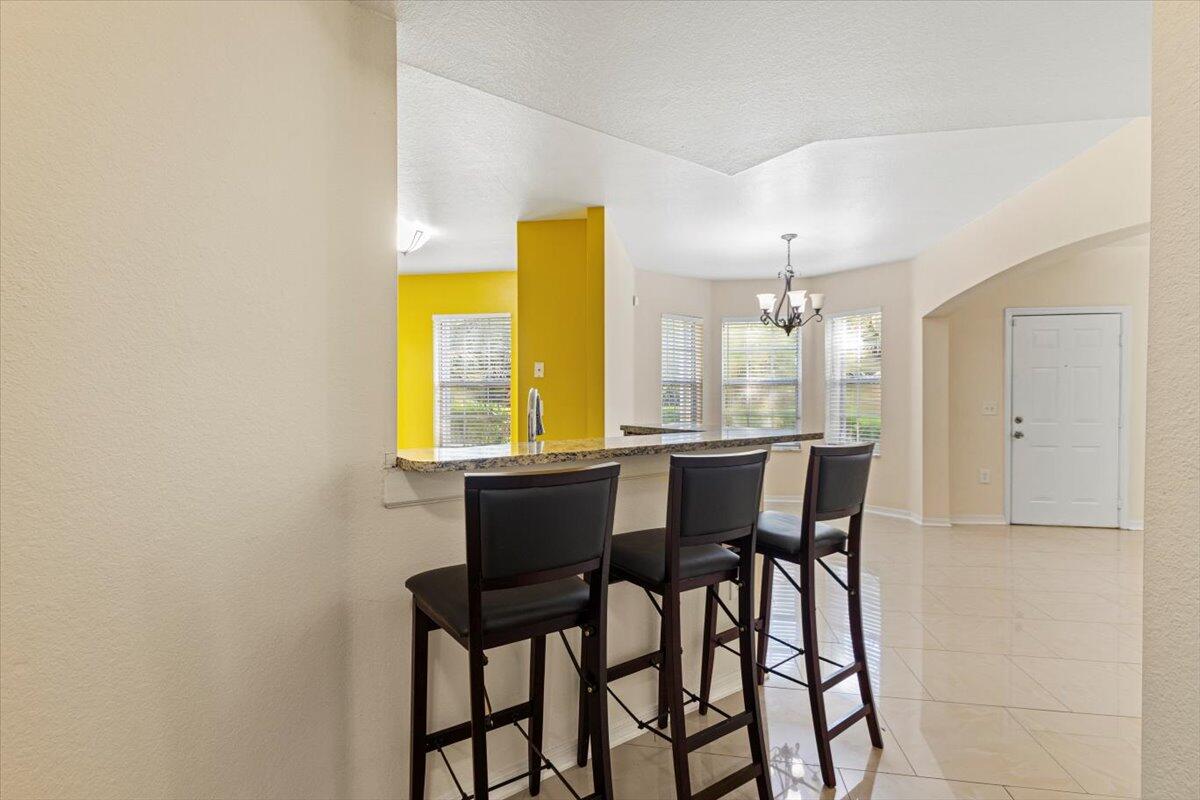 110 Southwest Peacock Boulevard, Unit 6101 Port St. Lucie, FL 34986 - Photo 17 of 70 a dining room with furniture and window
