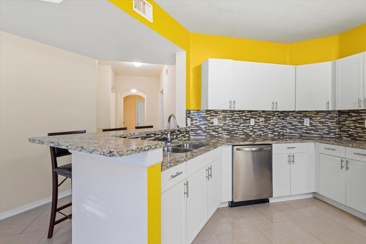 110 Southwest Peacock Boulevard, Unit 6101 Port St. Lucie, FL 34986 - Photo 19 of 70 a kitchen with a sink and cabinets