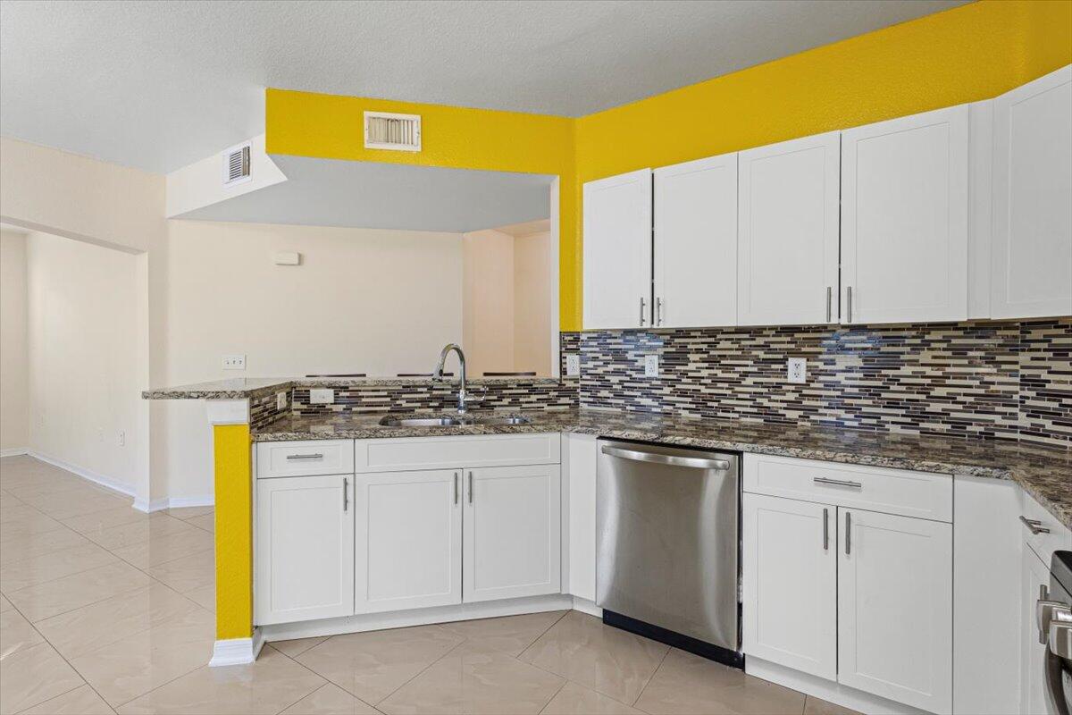 110 Southwest Peacock Boulevard, Unit 6101 Port St. Lucie, FL 34986 - Photo 23 of 70 a kitchen with a sink and cabinets