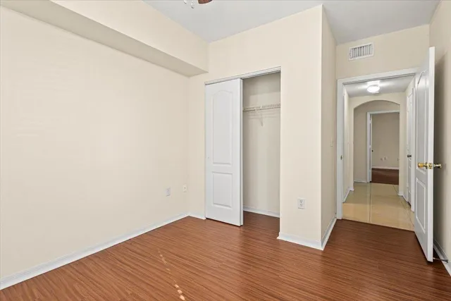 a bathroom with a granite countertop sink a toilet and mirror