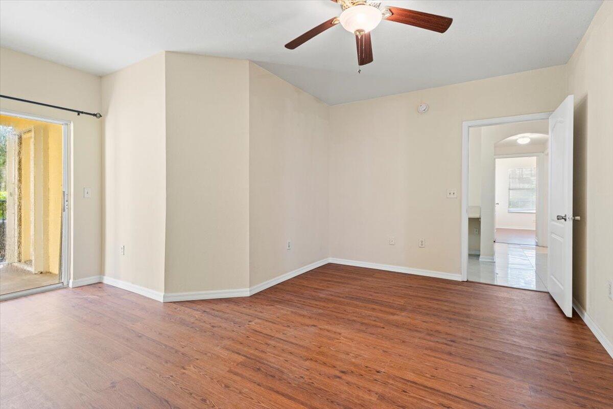 110 Southwest Peacock Boulevard, Unit 6101 Port St. Lucie, FL 34986 - Photo 30 of 70 wooden floor in an empty room with a window