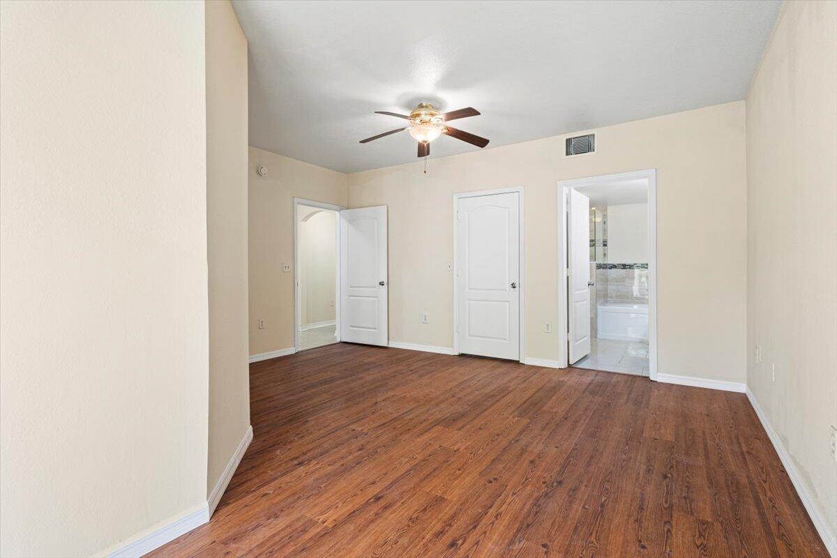 110 Southwest Peacock Boulevard, Unit 6101 Port St. Lucie, FL 34986 - Photo 31 of 70 a view of a room with wooden floor and a ceiling fan