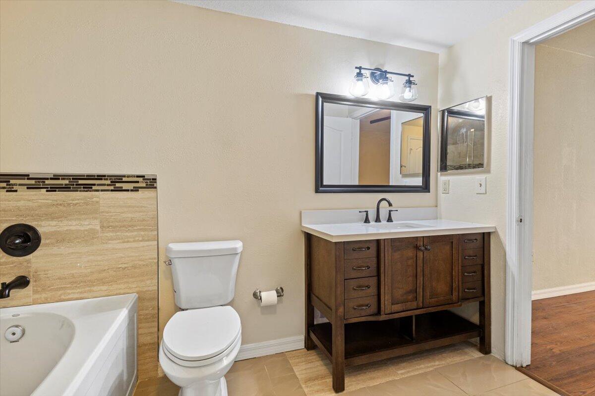 110 Southwest Peacock Boulevard, Unit 6101 Port St. Lucie, FL 34986 - Photo 33 of 70 a spacious bathroom with a toilet a sink a mirror and a faucet