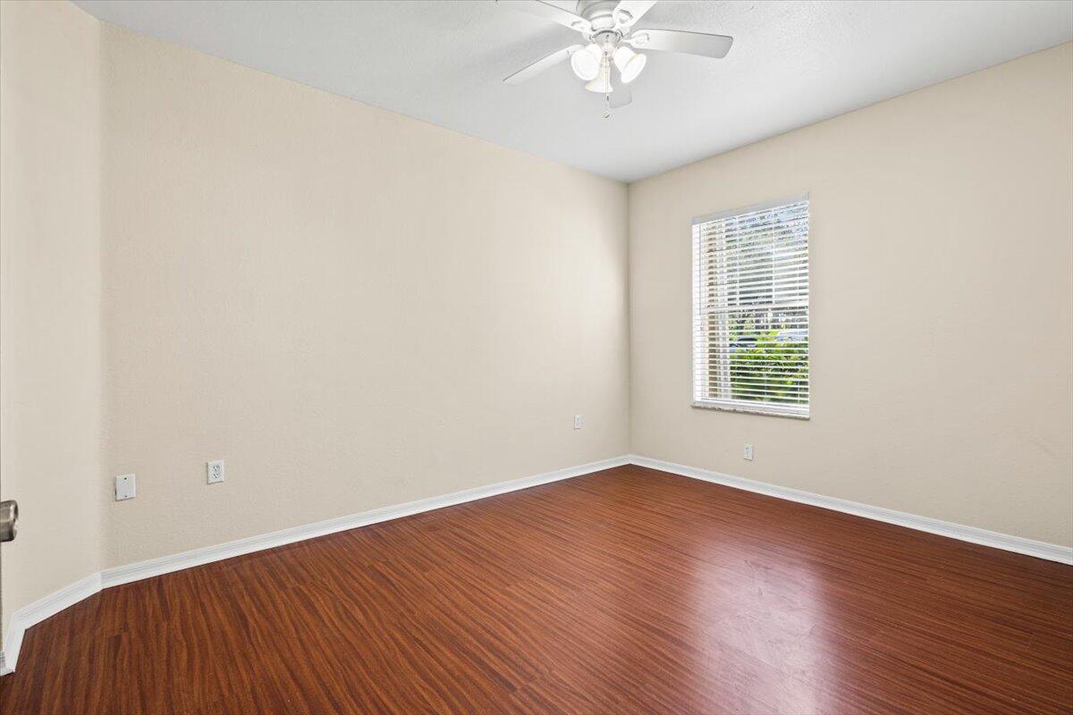 110 Southwest Peacock Boulevard, Unit 6101 Port St. Lucie, FL 34986 - Photo 35 of 70 a view of an empty room with wooden floor and a window