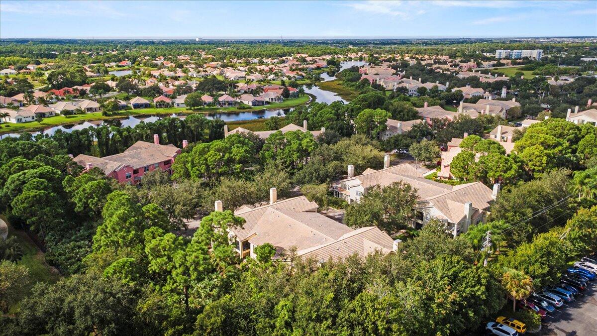 110 Southwest Peacock Boulevard, Unit 6101 Port St. Lucie, FL 34986 - Photo 45 of 70 an aerial view of a houses with a yard and lake