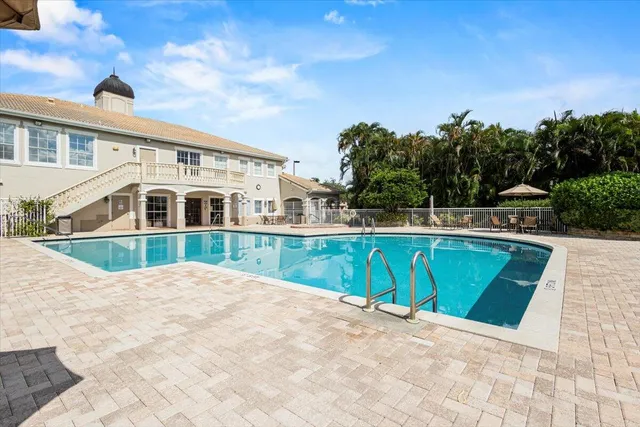 an aerial view of a house with swimming pool and glass doors