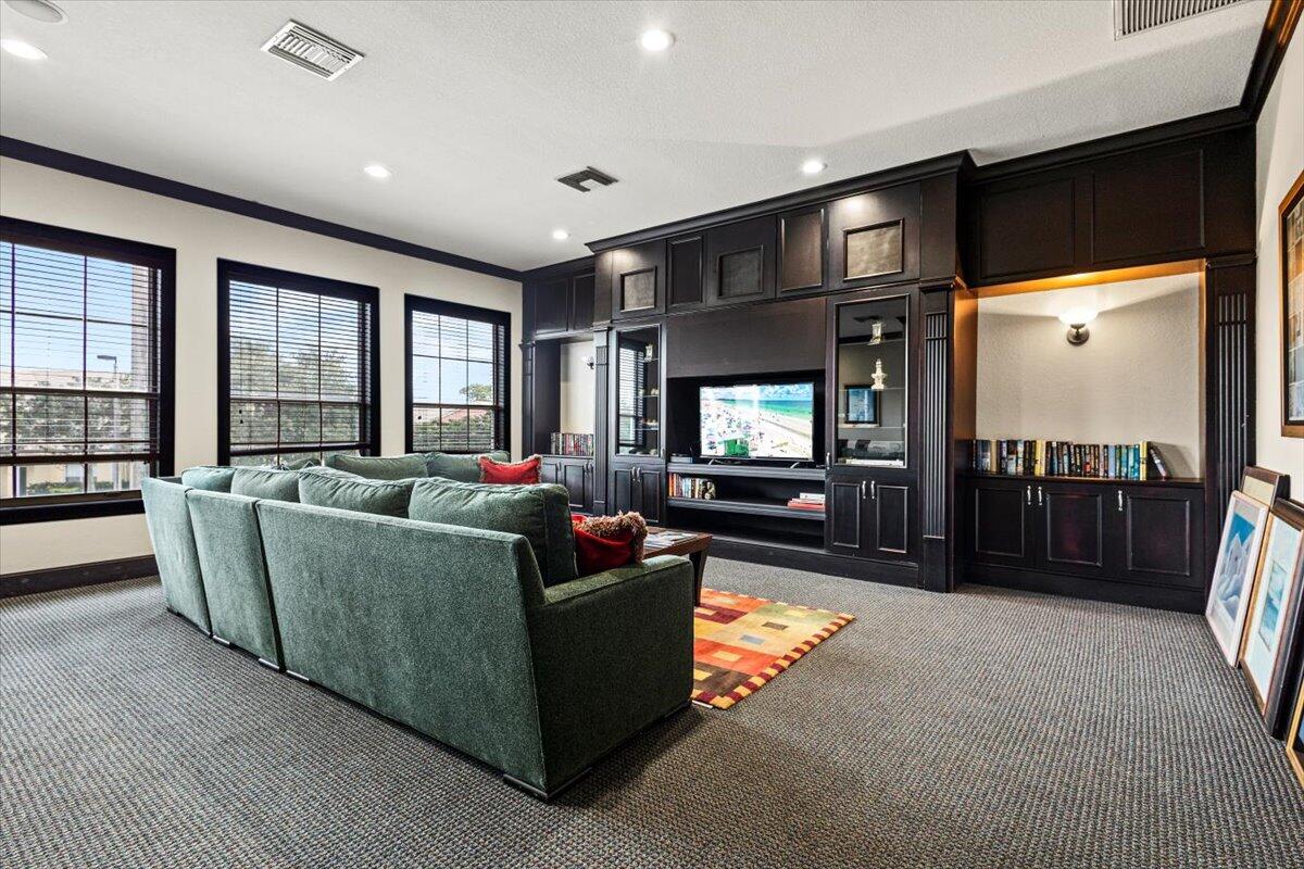 110 Southwest Peacock Boulevard, Unit 6101 Port St. Lucie, FL 34986 - Photo 58 of 70 a living room with furniture and a flat screen tv