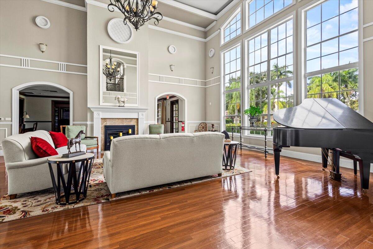 110 Southwest Peacock Boulevard, Unit 6101 Port St. Lucie, FL 34986 - Photo 60 of 70 a living room with furniture a fireplace and a floor to ceiling window