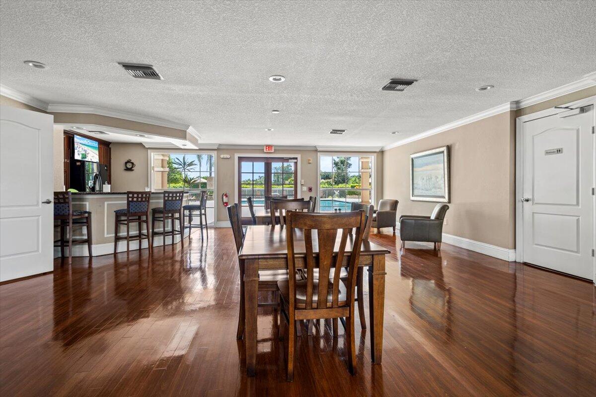 110 Southwest Peacock Boulevard, Unit 6101 Port St. Lucie, FL 34986 - Photo 61 of 70 a view of a dining room with furniture wooden floor and chandelier