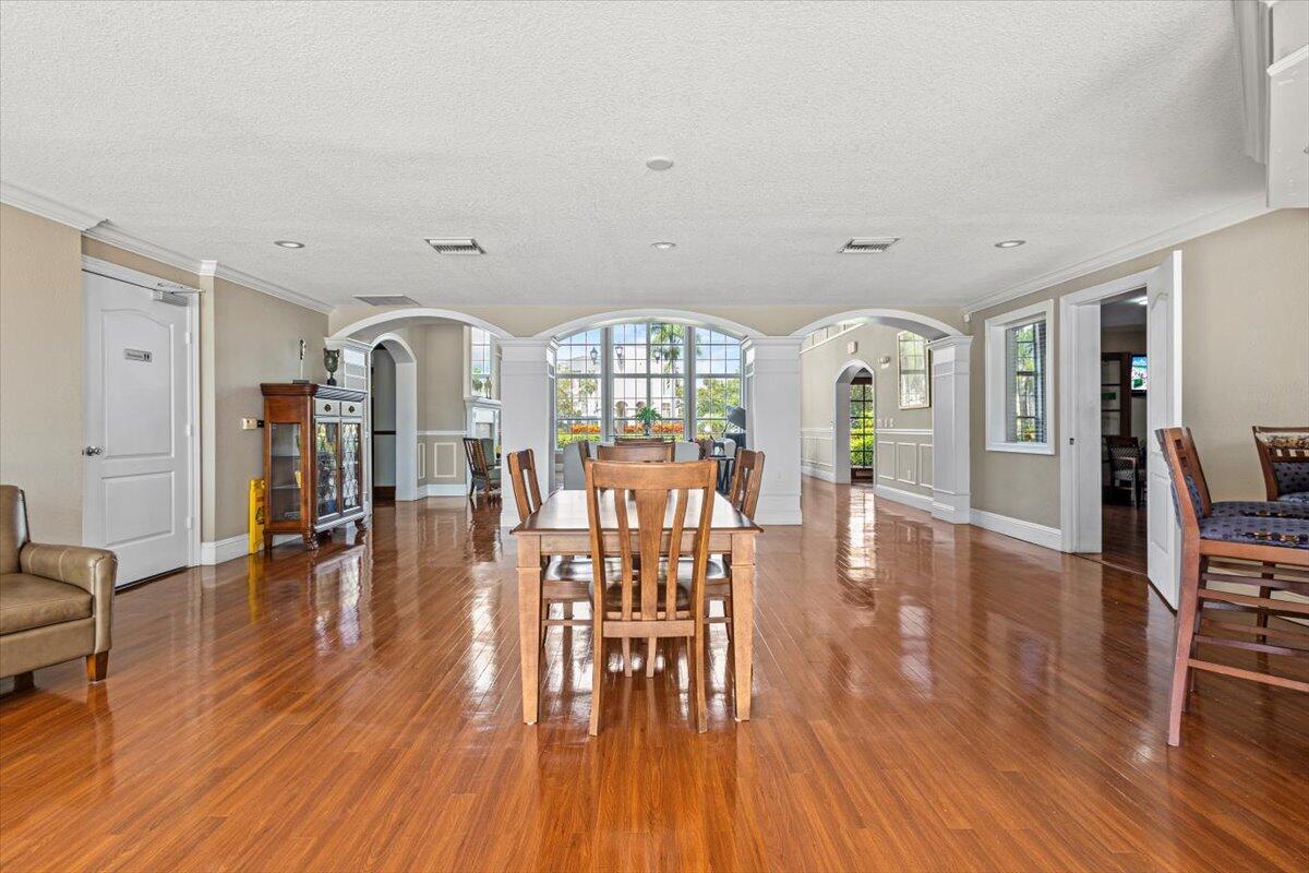 110 Southwest Peacock Boulevard, Unit 6101 Port St. Lucie, FL 34986 - Photo 63 of 70 a view of a dining room with furniture and wooden floor