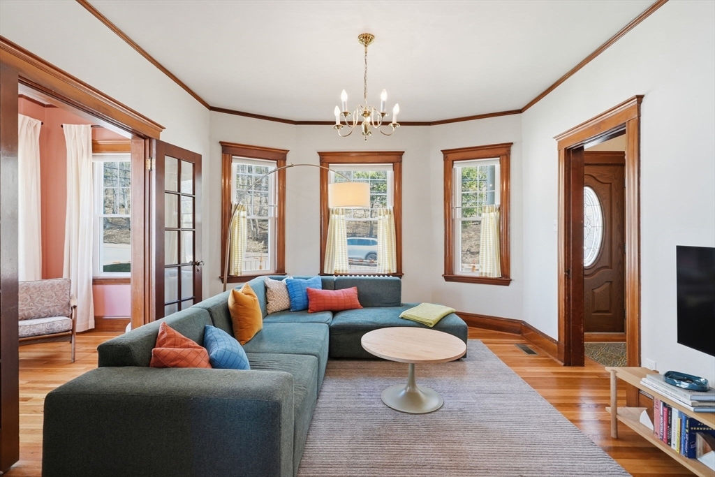 42 Lagrange Street, Unit U1 Boston, MA 02132 - Photo 1 of 42 a living room with furniture a rug and a chandelier
