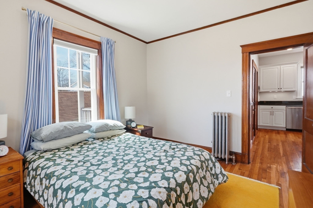 42 Lagrange Street, Unit U1 Boston, MA 02132 - Photo 19 of 42 a bedroom with a bed and a dresser next to a window