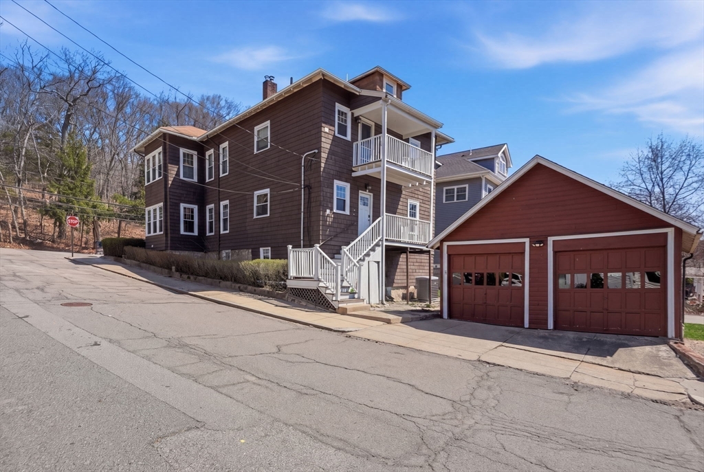 42 Lagrange Street, Unit U1 Boston, MA 02132 - Photo 29 of 42 a front view of a house with a yard